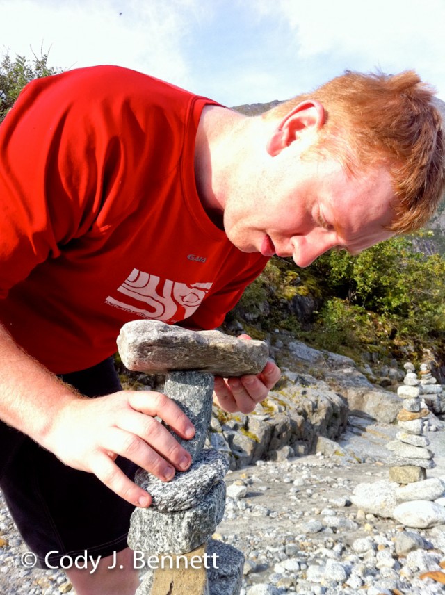 Cody adding to a cairn... Bonus points for using a piece of wood in the stack. Minus points for it falling by the time we came back by.